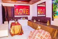 a room with couches and tables and a love sign at Keza Hotel in Kigali