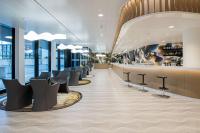 a restaurant with a row of chairs and a bar at Prize by Radisson, Bern City in Bern