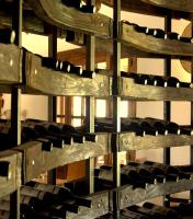 a wall of wooden wine racks in a wine cellar at Ardea Purpurea in Villamanrique de la Condesa