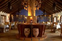 a dining room with a table with bottles of wine at Ardea Purpurea in Villamanrique de la Condesa