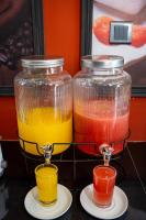 three glass containers filled with different colored juice at London Eye Hotel Nuwaraeliya in Nuwara Eliya
