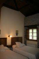Postel nebo postele na pokoji v ubytování Apartamentos Rurales El Palacio de Doiras