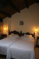 Postel nebo postele na pokoji v ubytování Apartamentos Rurales El Palacio de Doiras