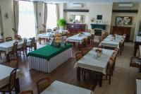 a restaurant with tables and chairs and a fireplace at Dom rekolekcyjny Vincentinum in Krzeszowice