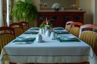 a table with plates and utensils on it at Dom rekolekcyjny Vincentinum in Krzeszowice