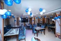 a banquet hall with blue and white balloons on the ceiling at Hotel Asian Comfort in Srinagar