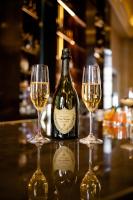 una botella de vino y dos copas en un bar en Hotel Crescent Court, en Dallas