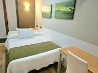 Łóżko lub łóżka w pokoju w obiekcie Hotel Olatu