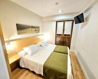 Łóżko lub łóżka w pokoju w obiekcie Hotel Olatu