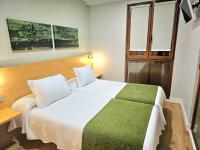 Łóżko lub łóżka w pokoju w obiekcie Hotel Olatu
