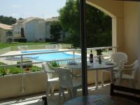 a patio with a table and chairs and a swimming pool at Moliets plage, Résidence OPEN SUD in Moliets-et-Maa