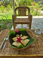 a plate of food on a wicker table at Amazing Ocean View Treehouse & Pool in Puerto Princesa City