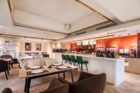 a restaurant with tables and chairs and a bar at CITIGO HOUSE Tianhe Guangzhou in Guangzhou