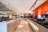 a large kitchen with a counter in a restaurant at CITIGO HOUSE Tianhe Guangzhou in Guangzhou
