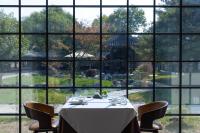 a table in a room with a large window at 北京水城一瓢私汤度假酒店 Beijing Aqua City YiPiao Hot Spring Resort in Beijing