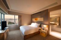 a hotel room with a bed and a large window at DoubleTree by Hilton Johor Bahru in Johor Bahru