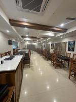 a large dining room with tables and chairs at Hotel Gokulam Grand in Pithāpuram