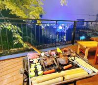 a grill with meat and vegetables on a balcony at Sapa Chill Retreat in Sa Pa