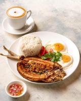 um prato de comida com arroz e uma chávena de café em San Juan Surf Resort La Union em San Juan