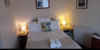 Postel nebo postele na pokoji v ubytování Windermere Lynwood Guest House