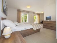 a bedroom with a bed and a television in it at Modern Villa in Povlja with Pool in Povlja