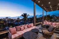 a living room with a couch and tables on a balcony at Hotel Riu Palace Tikida Agadir - All Inclusive in Agadir