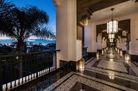 a hotel lobby with a view of the city at night at Hotel Riu Palace Tikida Agadir - All Inclusive in Agadir