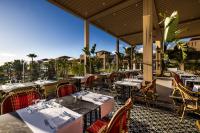 a restaurant with tables and chairs on a patio at Hotel Riu Palace Tikida Agadir - All Inclusive in Agadir