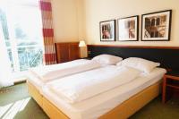 a bedroom with a large bed with two pillows at Vivotel Buerer Hof in Gelsenkirchen