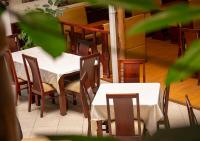 een eetkamer met tafels en stoelen met wit tafelkleed bij Hotel Coronel Centro Histórico in Cuenca