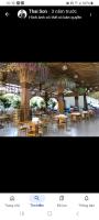 a picture of a restaurant with tables and trees at HoTel MoTeL ĐỒNG KHỞI in Ben Tre