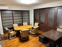 a conference room with a wooden table and chairs at Petit Hotel Hikobee in Kaga