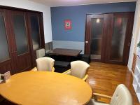 a conference room with a wooden table and chairs at Petit Hotel Hikobee in Kaga