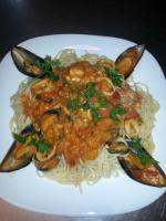 a plate of food with shrimp and noodles at Ela Mesa in Souvala