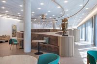 a lobby with a table and chairs and a statue at Buff Hotel & Resort Konstanz in Konstanz