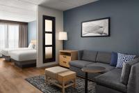 a living room with a couch and a bed at Hyatt Place Atlanta Airport North in Atlanta
