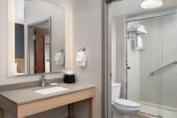 a bathroom with a sink and a toilet and a mirror at Hyatt Place Atlanta Airport North in Atlanta