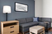 a living room with a gray couch and a table at Hyatt Place Atlanta Airport North in Atlanta