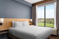 a bedroom with a large bed and a large window at Hyatt Place Atlanta Airport North in Atlanta