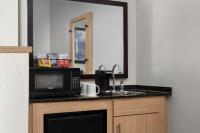 a kitchen with a microwave and a sink and a mirror at Hyatt Place Atlanta Airport North in Atlanta
