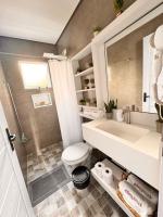 a bathroom with a sink and a toilet at La Estancia Residencial in Iguape