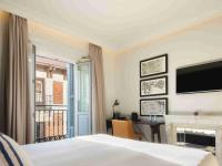 a bedroom with a bed and a desk and a television at Only YOU Boutique Hotel Madrid in Madrid