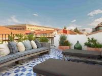 a patio with couches and tables on a roof at Only YOU Boutique Hotel Madrid in Madrid