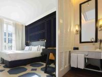 a bedroom with a bed and a sink and a mirror at Only YOU Boutique Hotel Madrid in Madrid