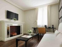 a living room with a fireplace with a tv above it at Only YOU Boutique Hotel Madrid in Madrid