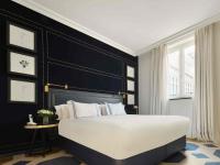 a bedroom with a large bed with a black headboard at Only YOU Boutique Hotel Madrid in Madrid