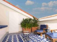 a balcony with blue chairs and a blue and white floor at Only YOU Boutique Hotel Madrid in Madrid