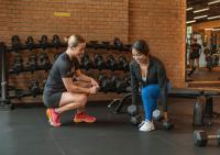 a man and a woman in a gym with weights at Stay Wellbeing & Lifestyle Resort in Rawai Beach