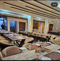 a large dining room with tables and chairs at Hotel KNG Grand in Fatehpur Sīkri