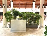 a large room with potted plants in a building at Horse Country Resort Congress & Spa - Hotel Castello in Arborea 